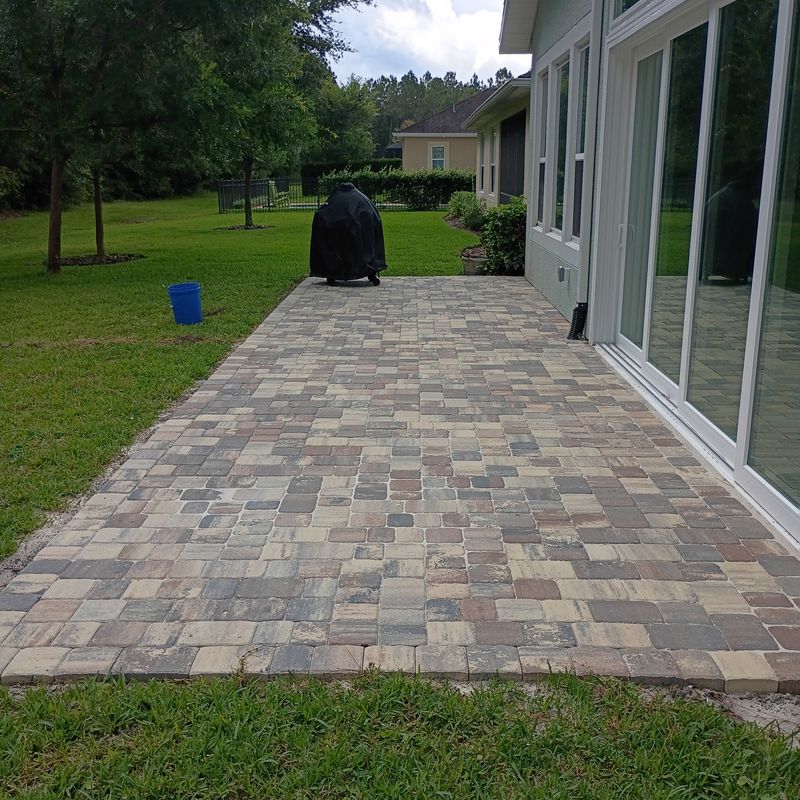 Finished paver patio installation beside a home in Volusia County